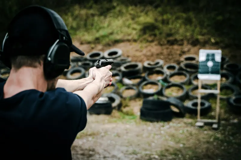 Outdoor shooting range with a tire-wall backstop behind the targets